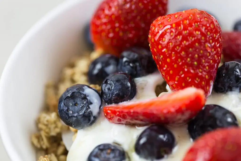 Dish of granola with berries and yoghurt