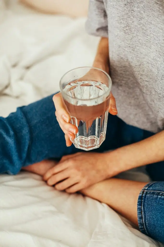 Person holding a glass of water