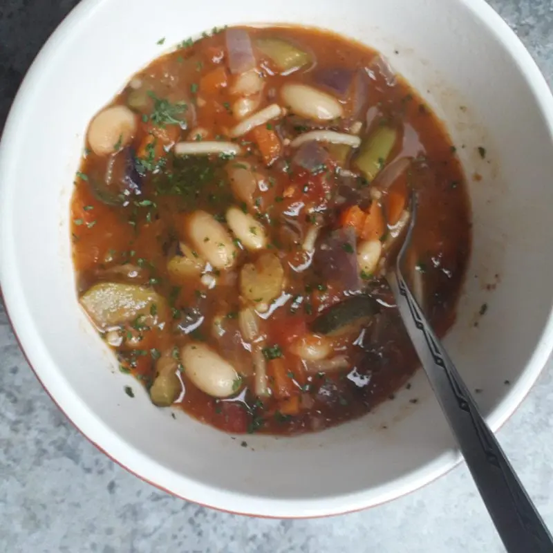 Bowl of minestrone soup with spoon in it