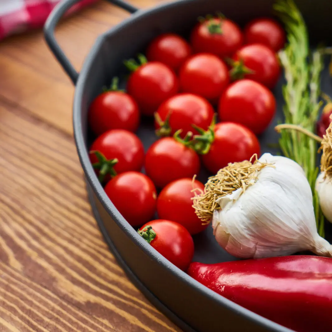 Dish filled with tomatoes, garlic, onions and peppers